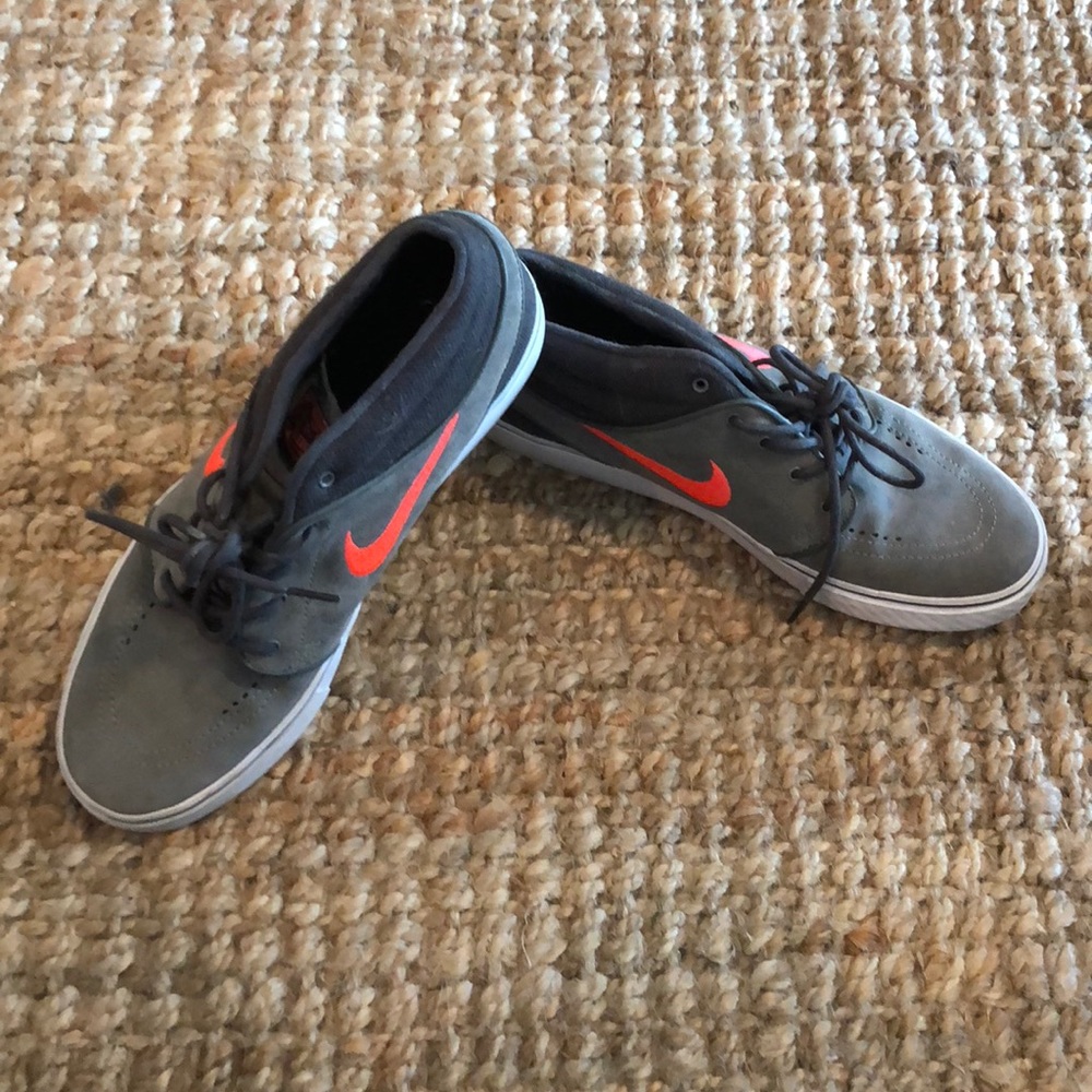 Grey nikes with orange swoosh